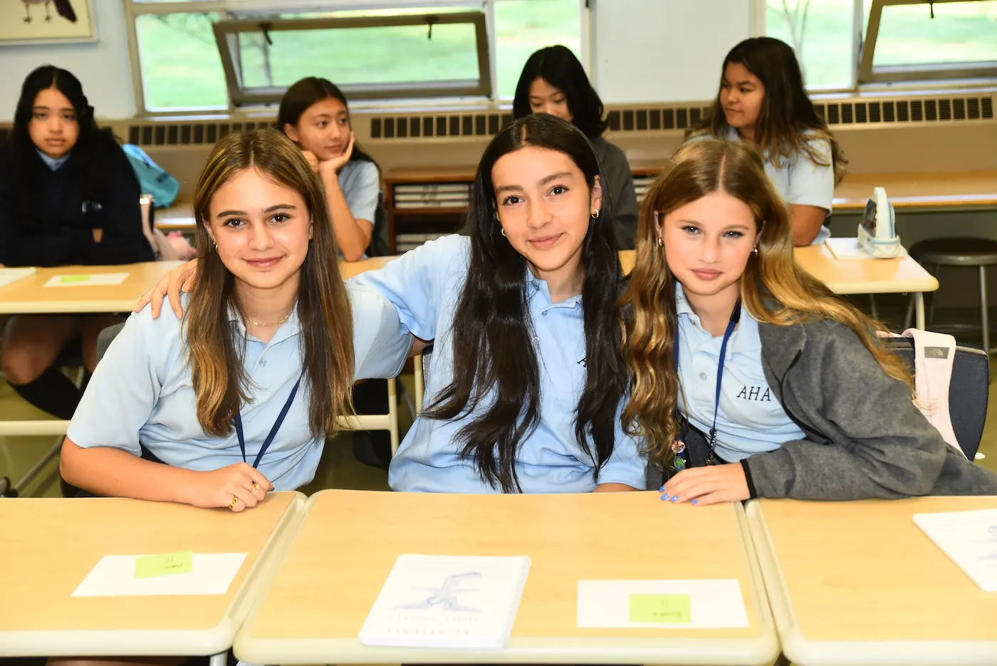 AHA Students sitting together at a desk in class